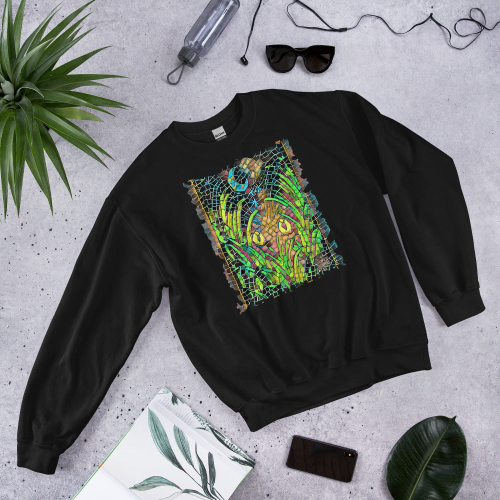 Black unisex sweatshirt featuring “Midnight Watcher” artwork in Amber Collection mosaic style (glowing yellow eyes in green grass under a crescent moon)