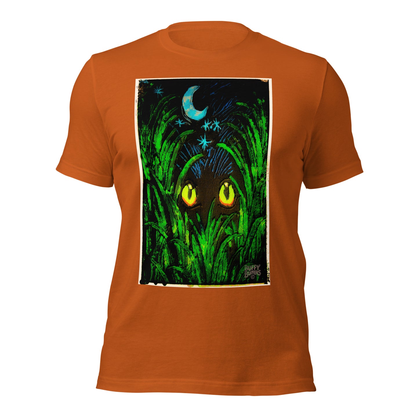 Autumn orange unisex t-shirt featuring "Midnight Watcher" artwork – glowing yellow eyes in green grass under a crescent moon (Canva Collection)