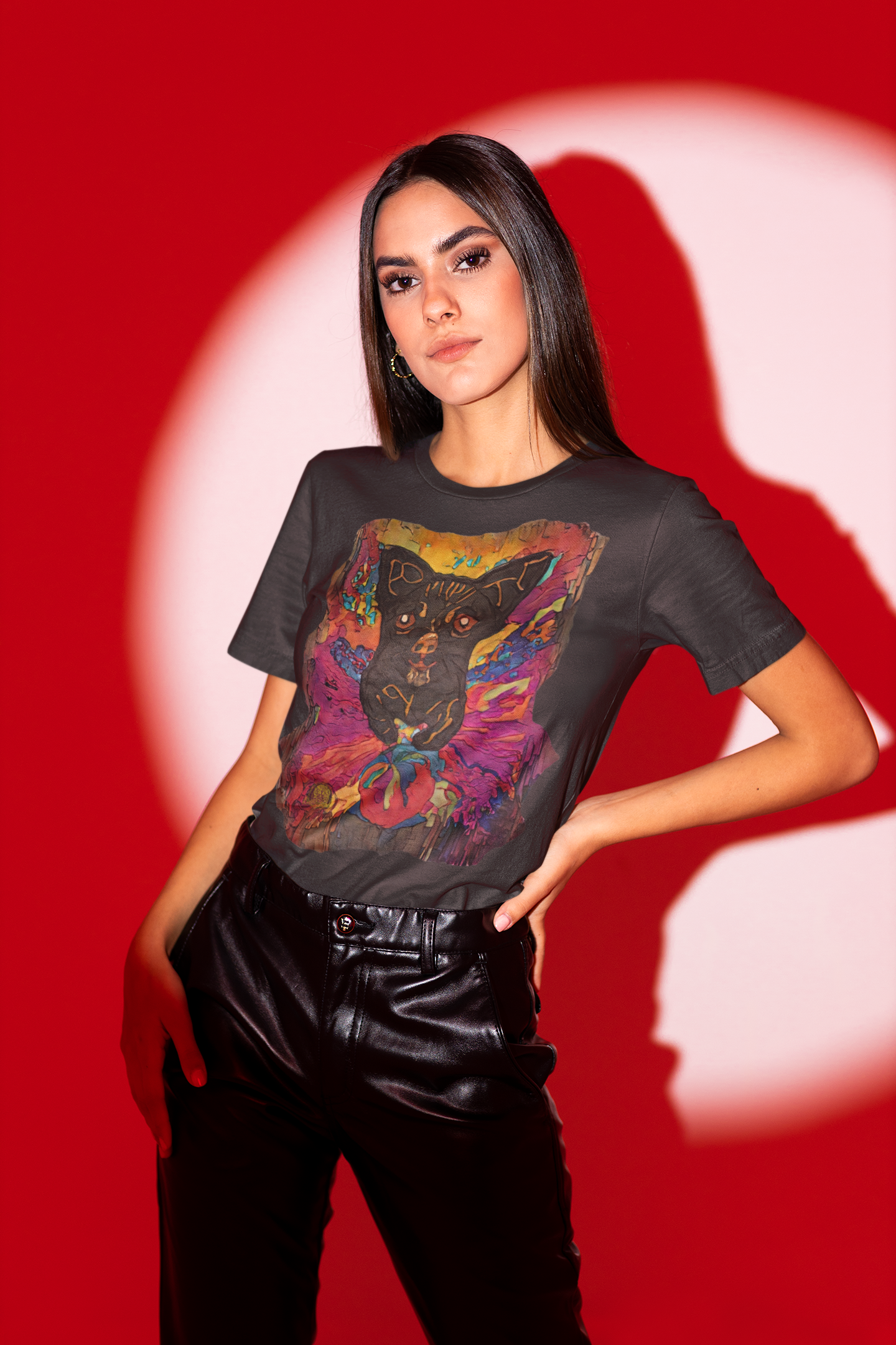 Woman wearing a black t-shirt with a colorful graphic design on a red background